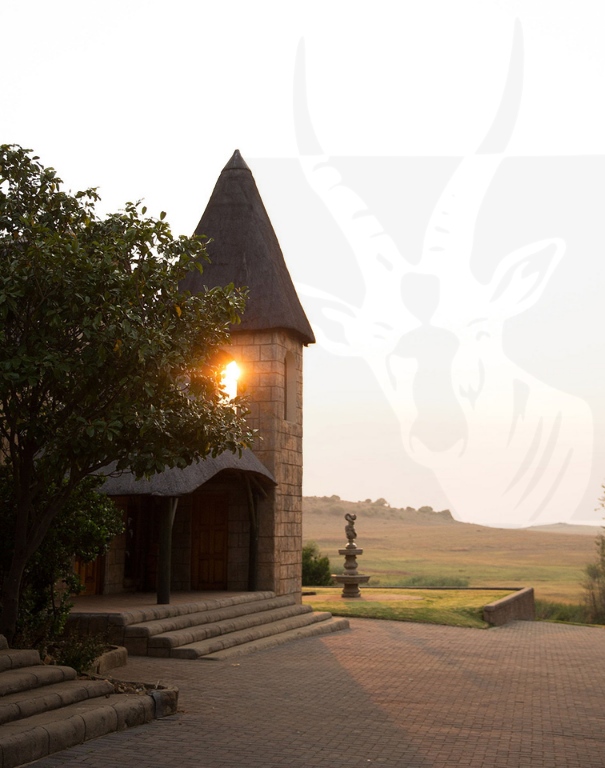 Thatched lodge building at sunset