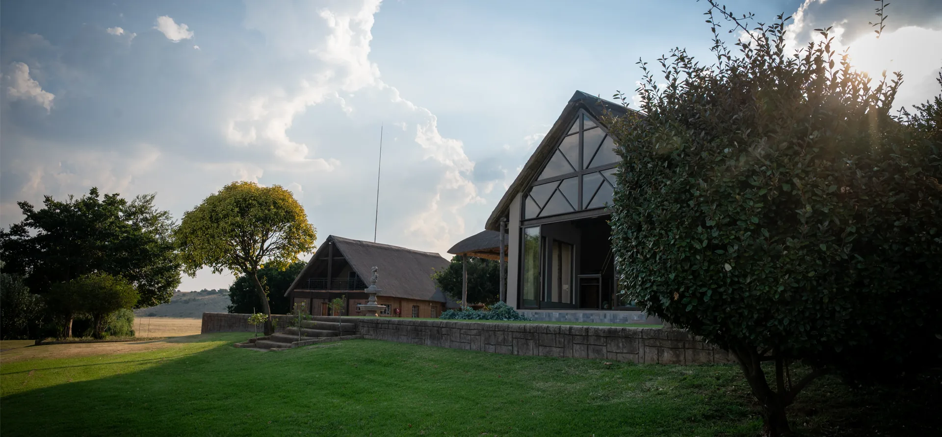 Thatched lodge building at sunset